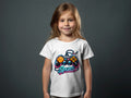 Child wearing a white t-shirt with a neon video game controller and "Spurs" text graphic.