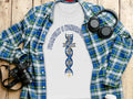 White t-shirt with "Fearfully & Wonderful" text and DNA cross graphic, laid flat with plaid shirt.