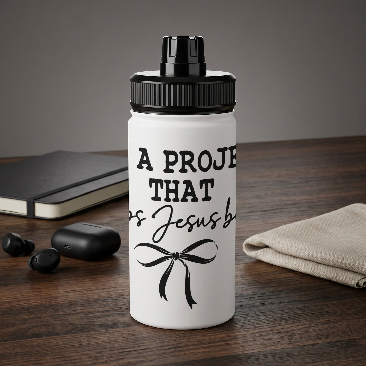 White water bottle with black text "A project that is Jesus blessed" and bow.