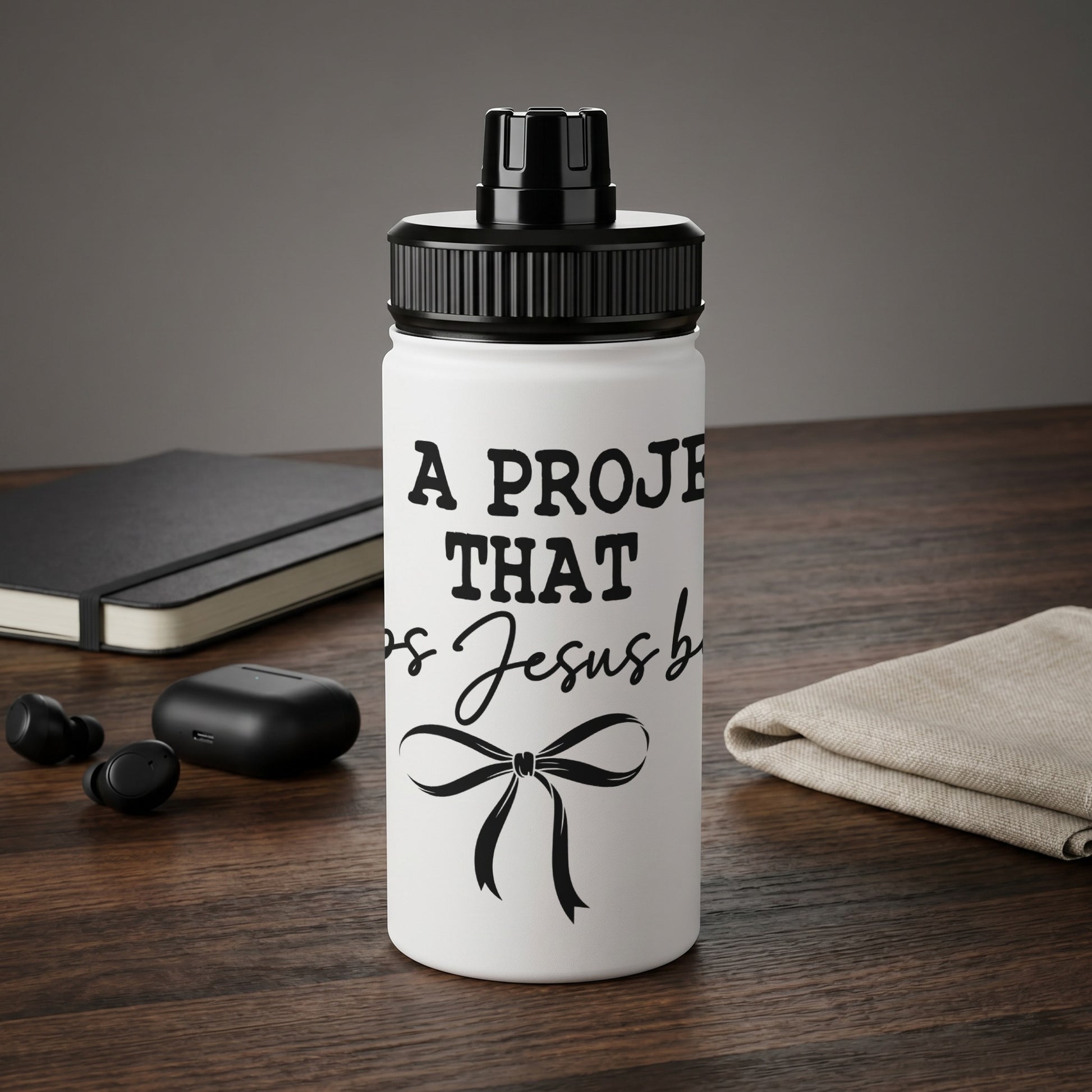 White water bottle with black text "A project that is Jesus blessed" and bow.