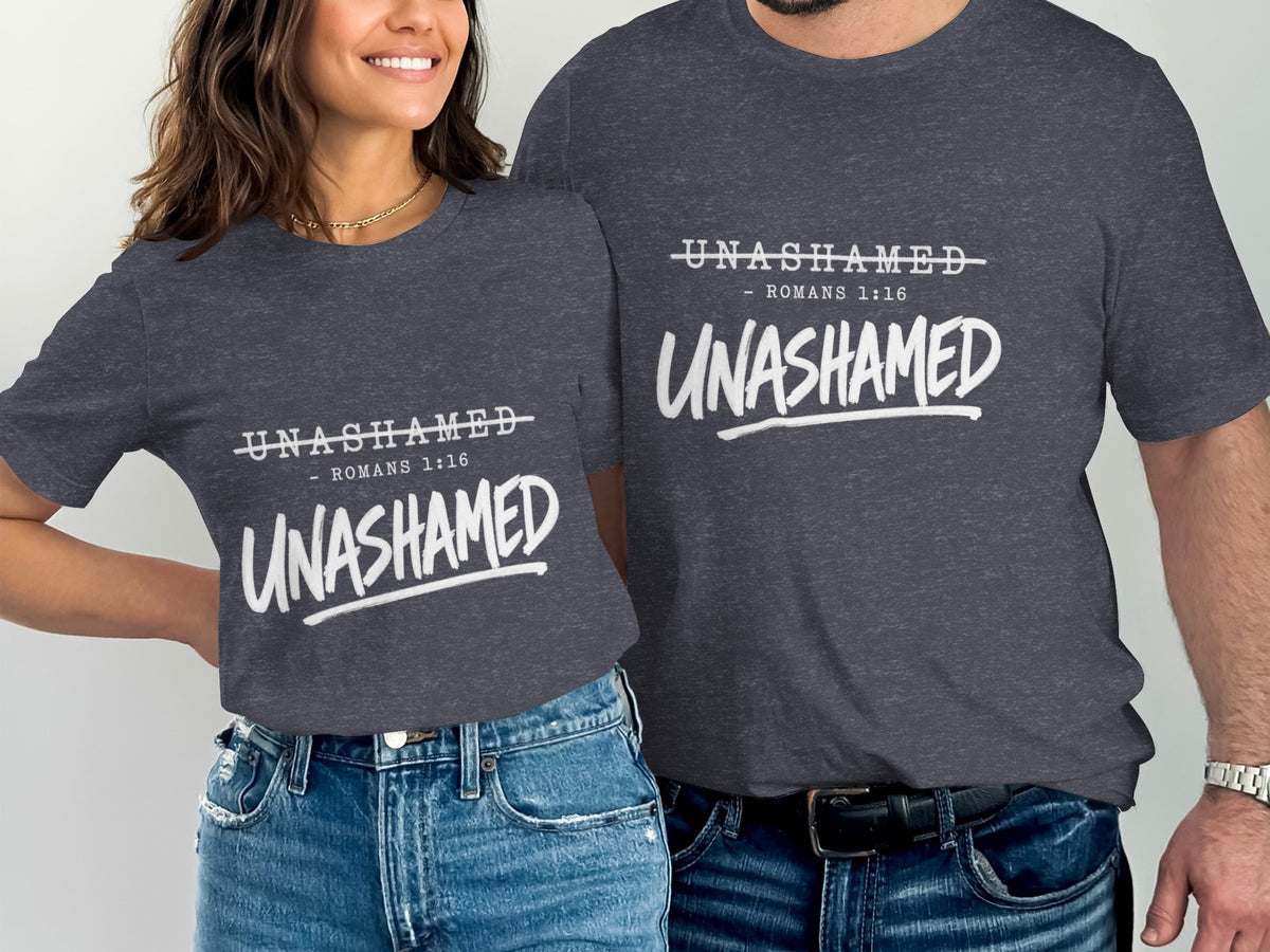 Two people wear charcoal gray t-shirts with white text: Unashamed Romans 1:16.