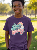Boy wearing purple t-shirt with "Little Blessing" text and rainbow graphic.
