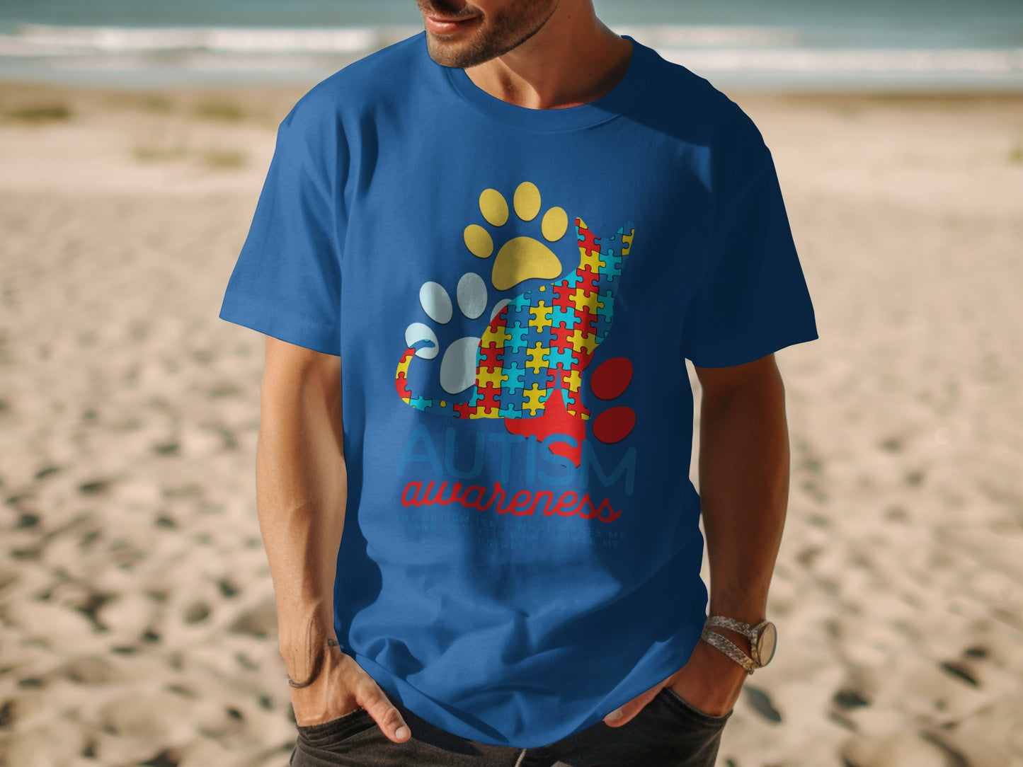 Blue t-shirt with autism awareness cat graphic and paw prints.