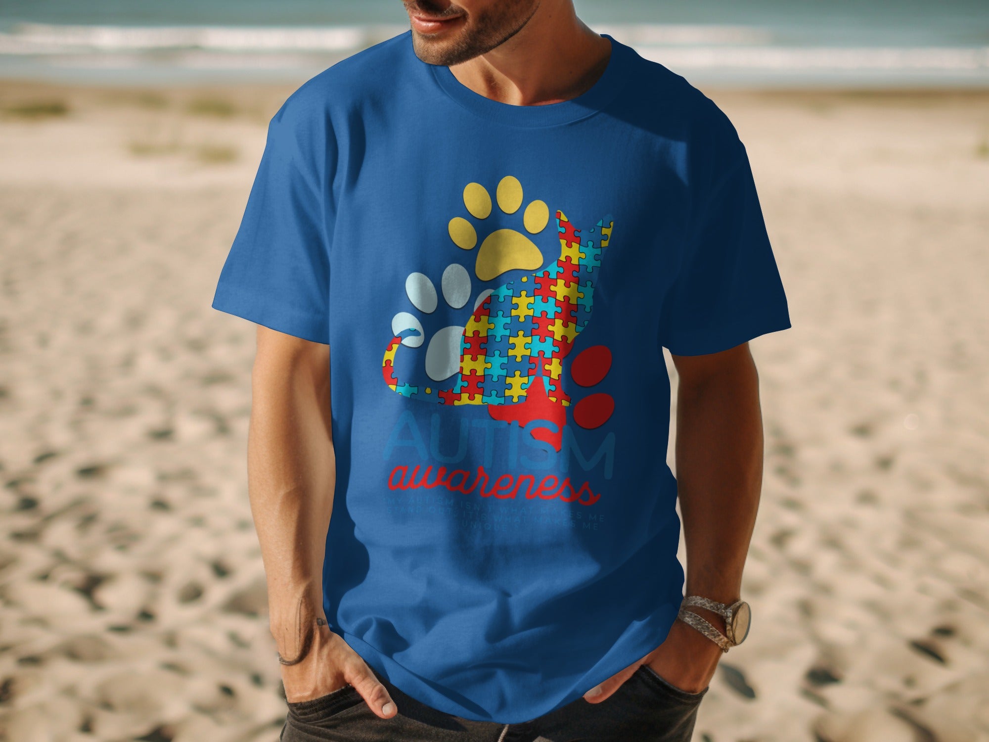 Blue t-shirt with autism awareness cat graphic and paw prints.