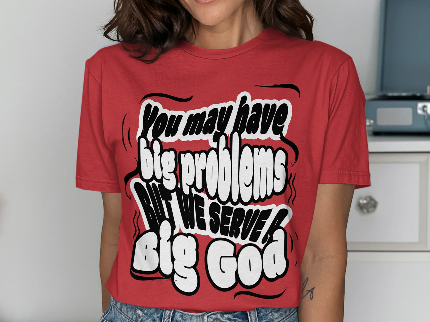 Red t-shirt with text "You may have big problems BUT WE SERVE big God".
