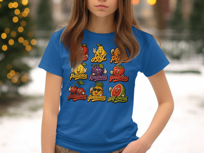 Cartoon fruits with positive words like joy, peace, and goodness on a blue t-shirt.