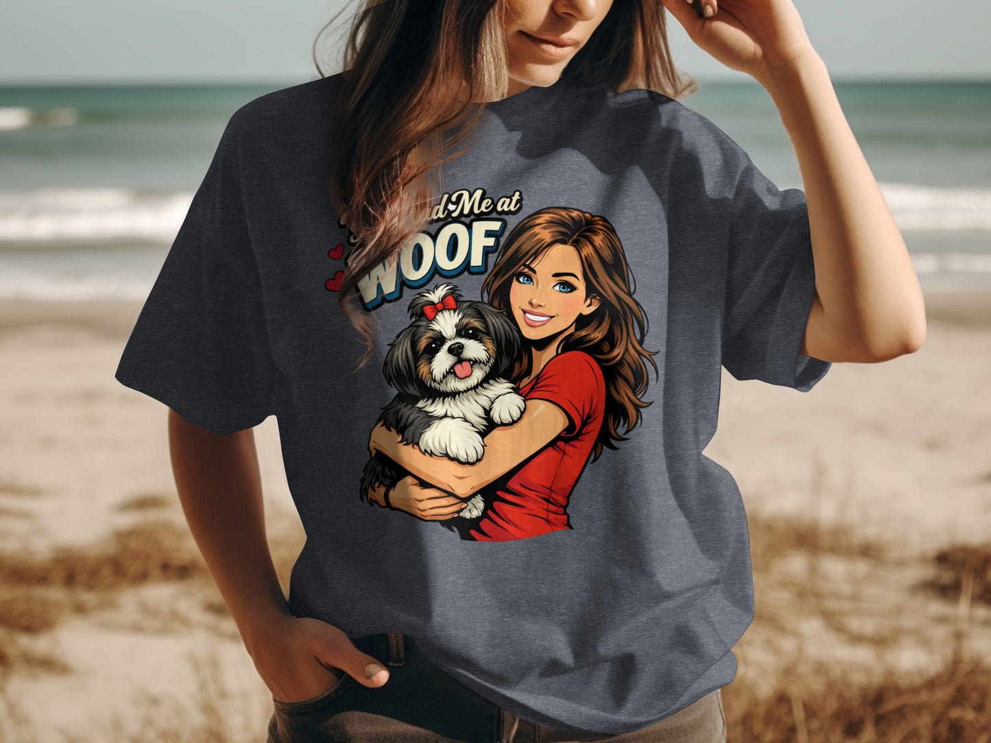 Woman holding a shih tzu with text "Find Me at WOOF" on t-shirt.