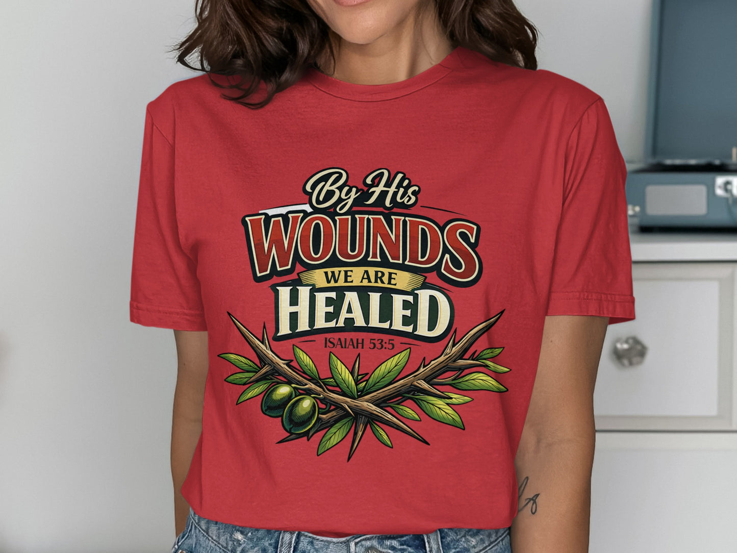 Red t-shirt with "By His Wounds We Are Healed Isaiah 53:5" and olive branch design.