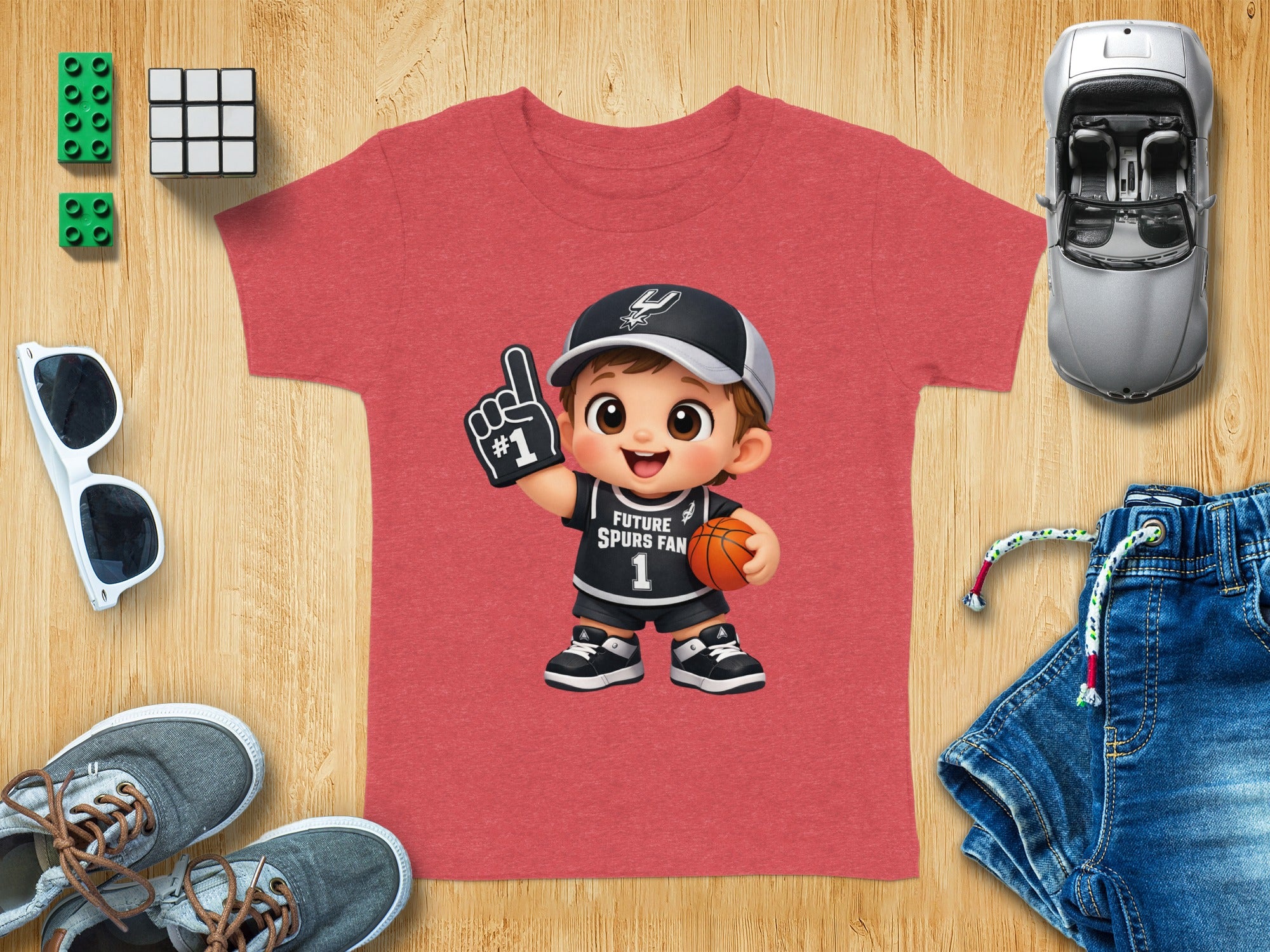 Kid's t-shirt with cartoon basketball player graphic and "Future Spurs Fan" text.