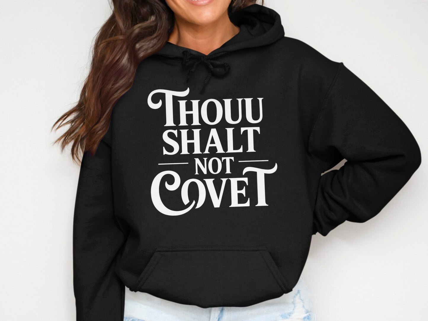 Black hoodie with white text that reads "THOUU SHALT NOT COVE T".
