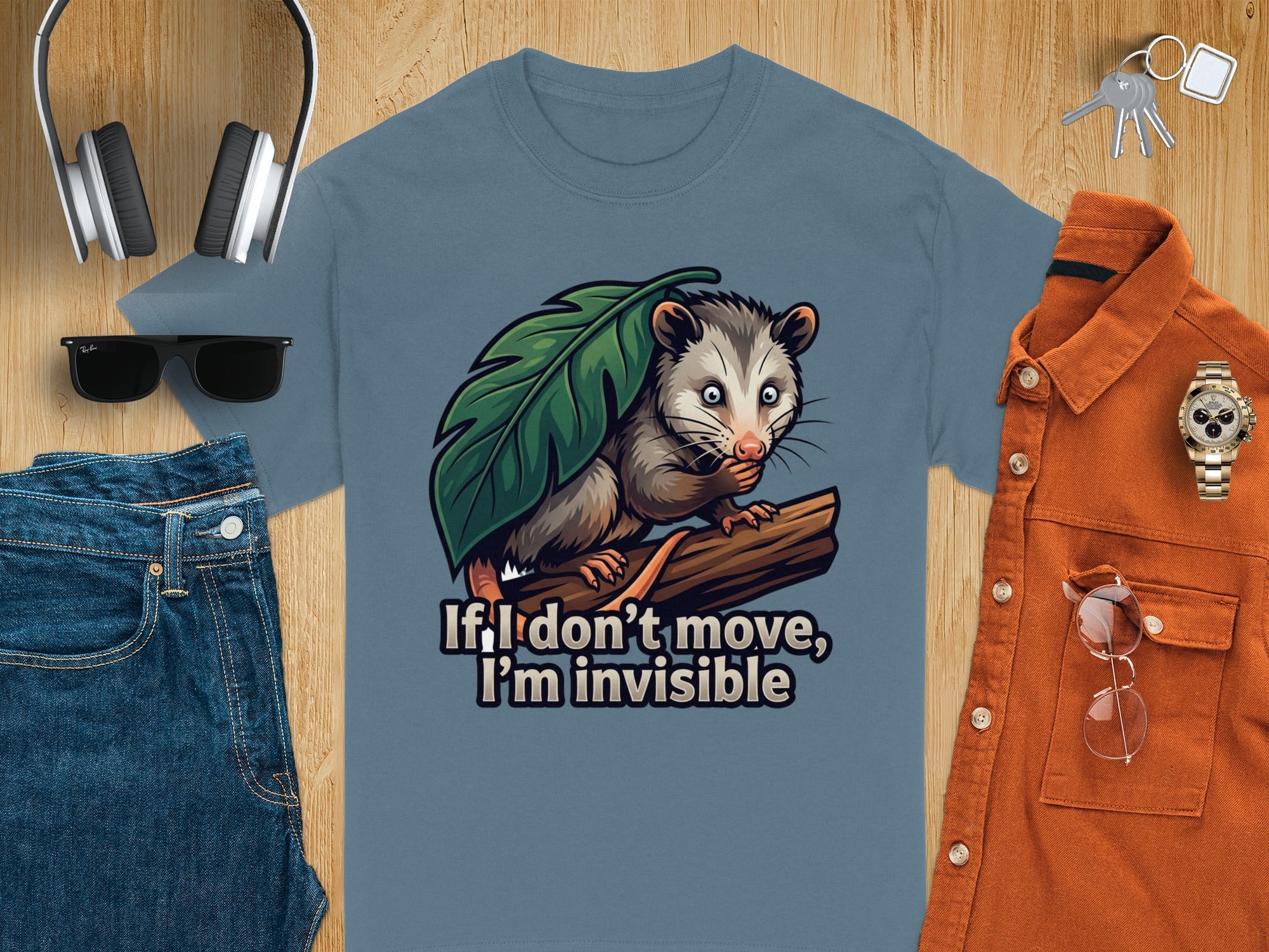 Opossum on a branch under a leaf with text "If I don't move, I'm invisible".