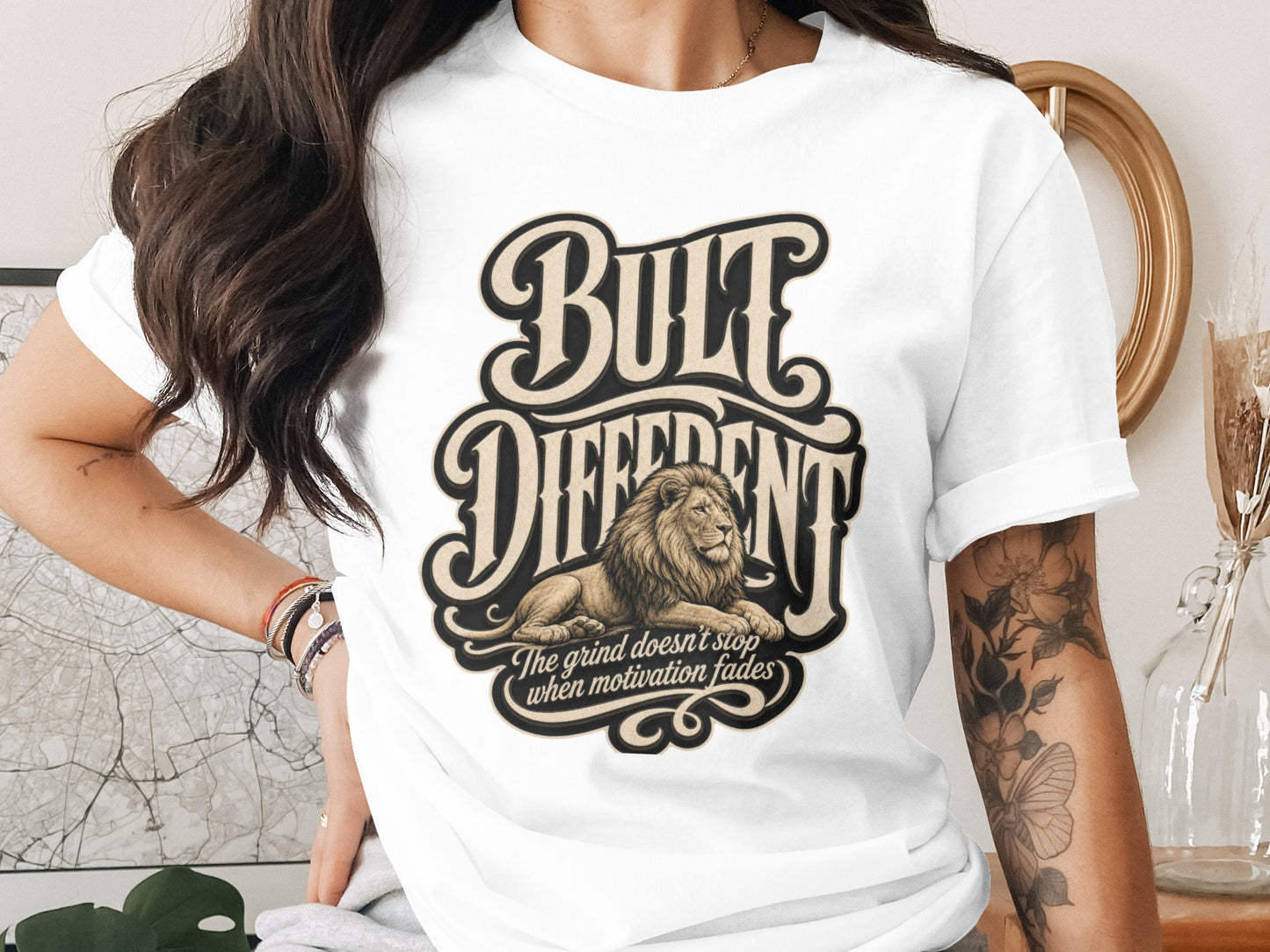 White t-shirt with "Bult Different" graphic and lion. "The grind doesn't stop when motivation fades."