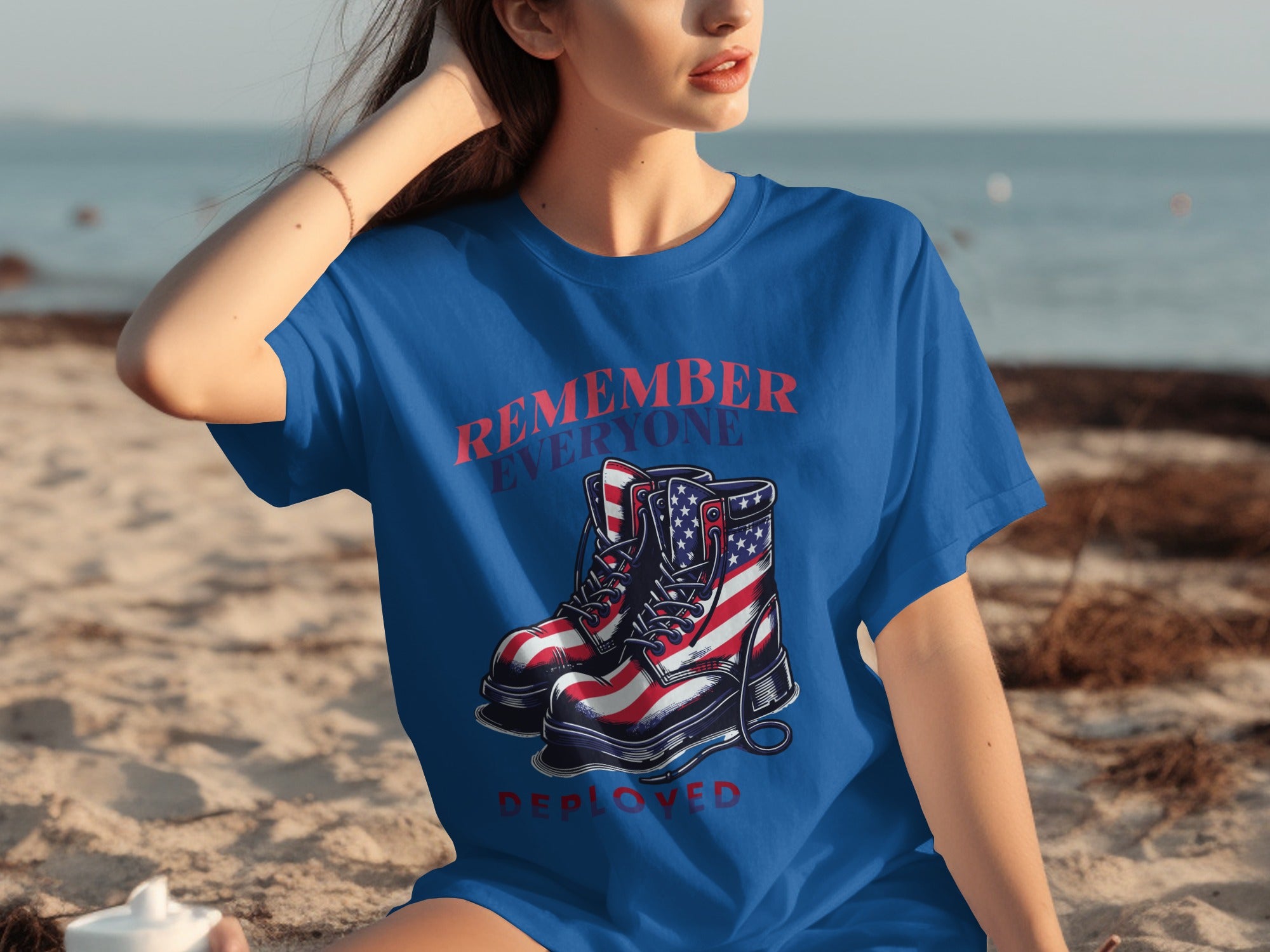 Blue t-shirt with graphic of US flag boots and text "REMEMBER EVERYONE DEPLOYED".