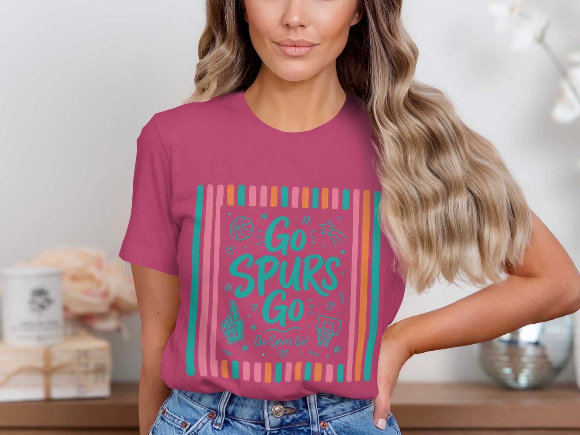 Pink t-shirt with "Go Spurs Go" in teal text and basketball graphics.