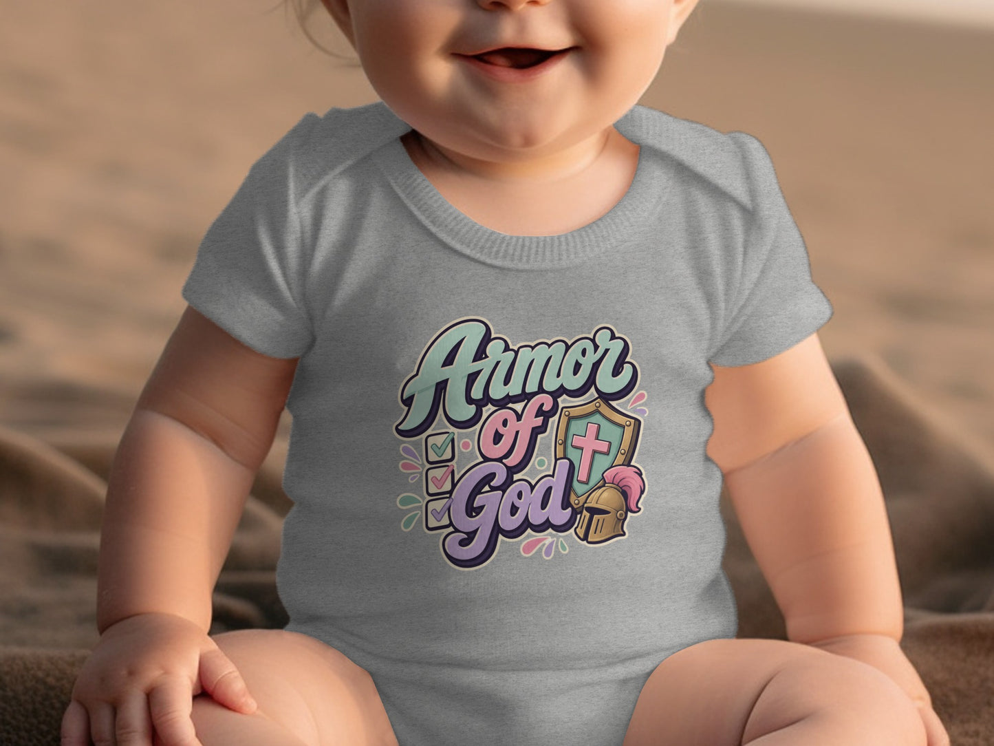 Baby wearing grey bodysuit with "Armor of God" text and shield graphic.