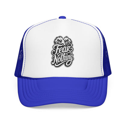Trucker hat with white front panel and blue mesh back, featuring "Fear Nothing" text and imagery.