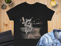 Raccoon wearing sunglasses plays cricket with bat and ball on a dark background.