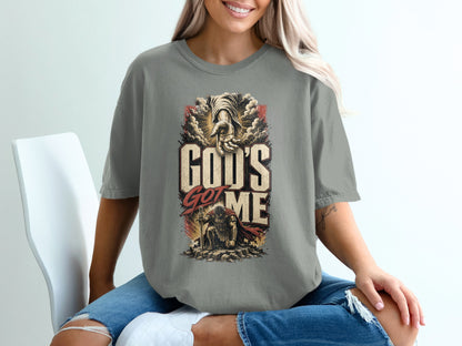 T-shirt with "God's Got Me" text, a reaching hand, and kneeling warrior graphic.