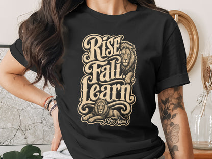 Black t-shirt with "Rise Fall Learn Rise Again" text and two lions.