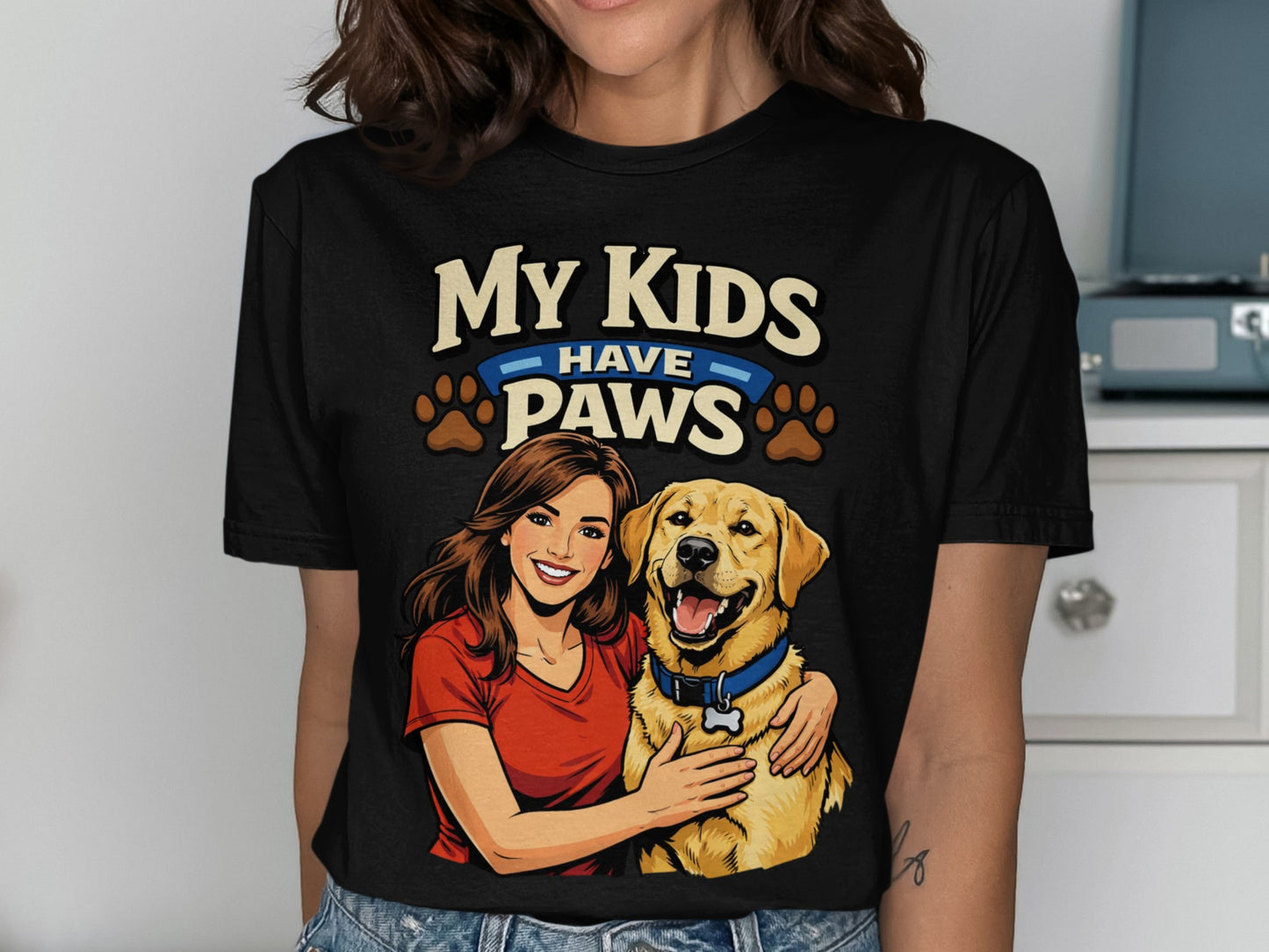Black t-shirt graphic with text "My Kids Have Paws" featuring a woman hugging a dog.