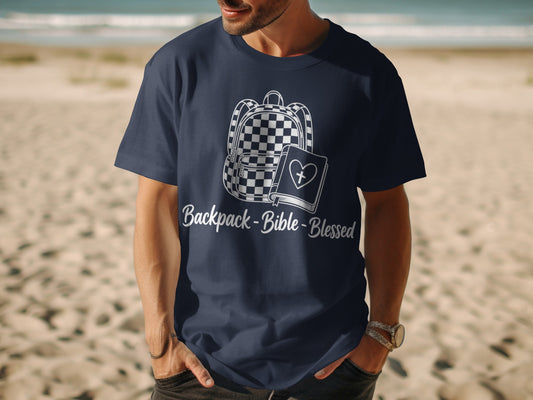 Navy t-shirt with a checkered backpack, Bible, and "Backpack-Bible-Blessed" text.