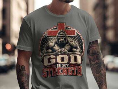 Grey t-shirt with gorilla, cross, and text "GOD IS MY STRENGTH" graphic.
