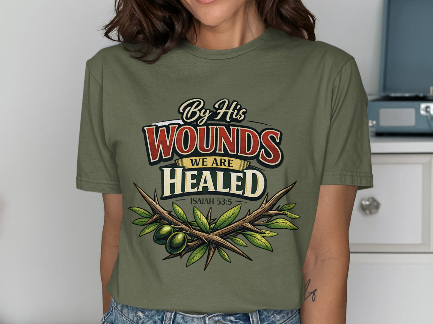 Olive branches and text "By His Wounds We Are Healed Isaiah 53:5" on shirt.