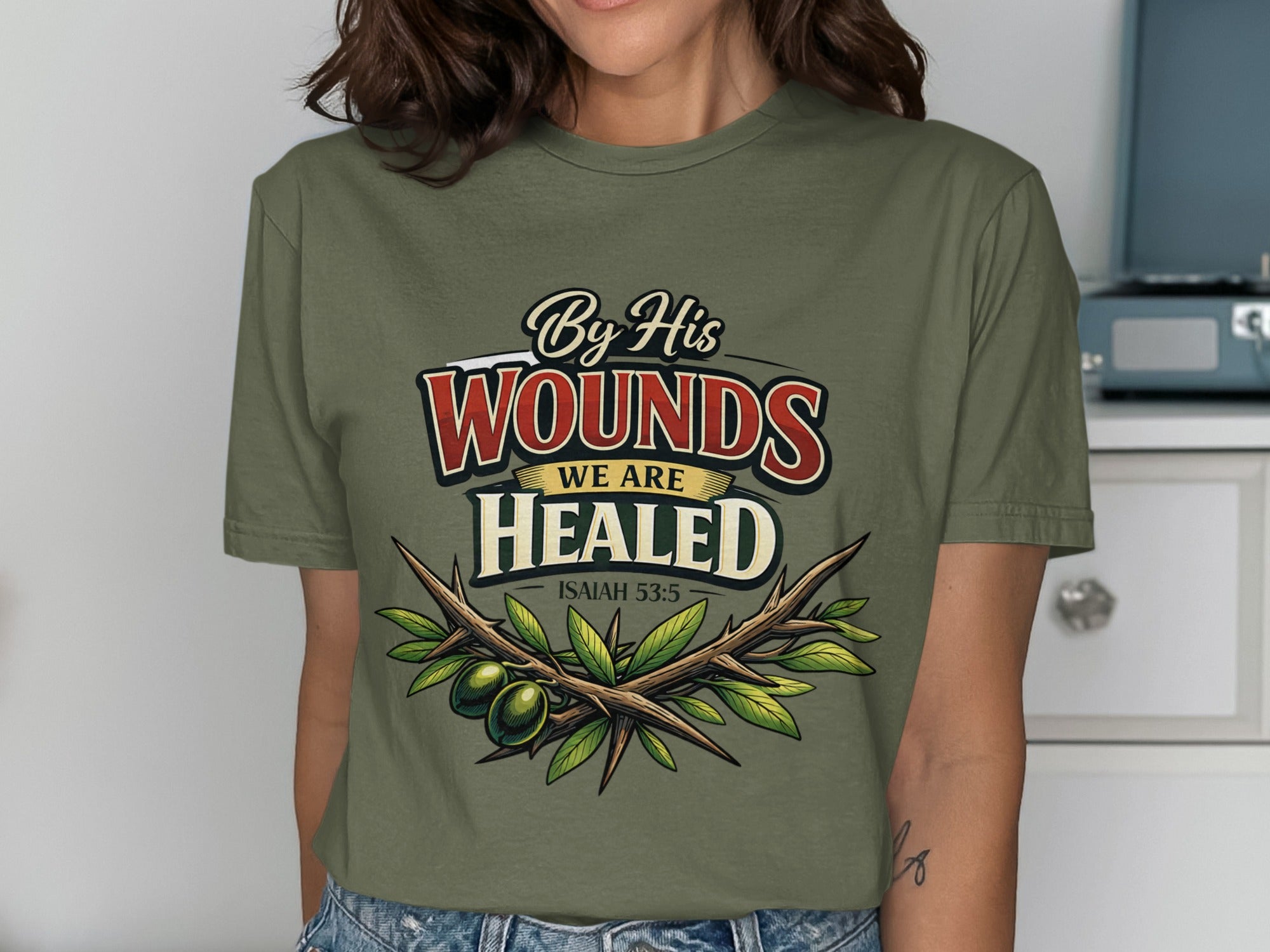 Olive branches and text "By His Wounds We Are Healed Isaiah 53:5" on shirt.