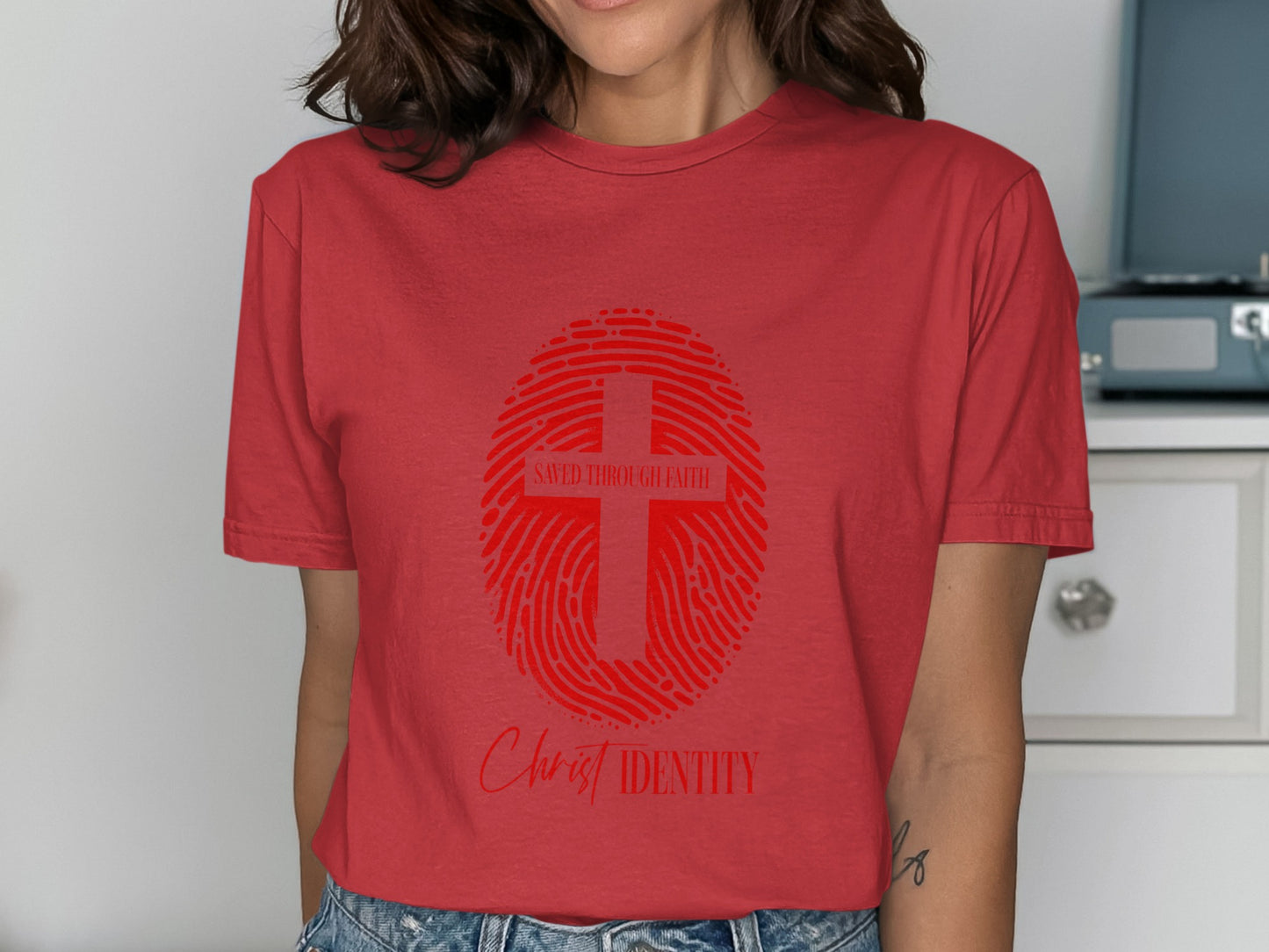 Red t-shirt with a red fingerprint graphic containing a cross and text.