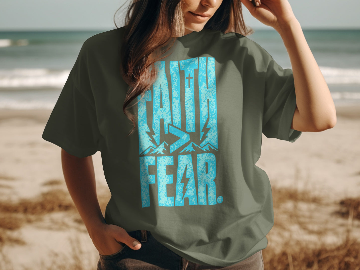 Olive green t-shirt with blue "FAITH > FEAR." text and mountain graphics.