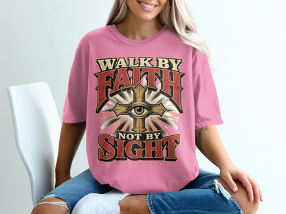 Pink t-shirt with text "Walk by Faith Not by Sight" and eye and cross design.