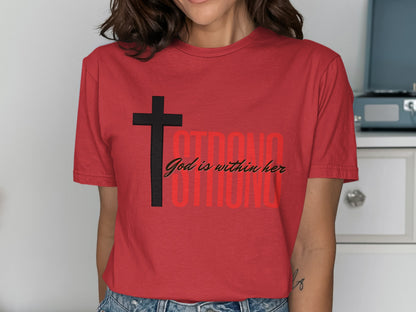 Red t-shirt with black cross and "God is within her" text.