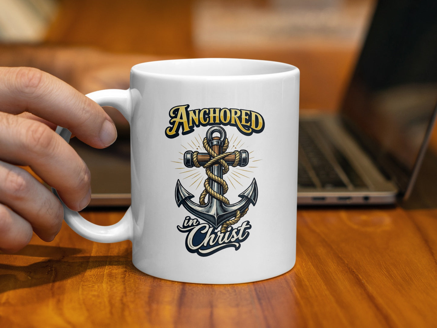 White mug with "Anchored in Christ" text and an anchor cross design.