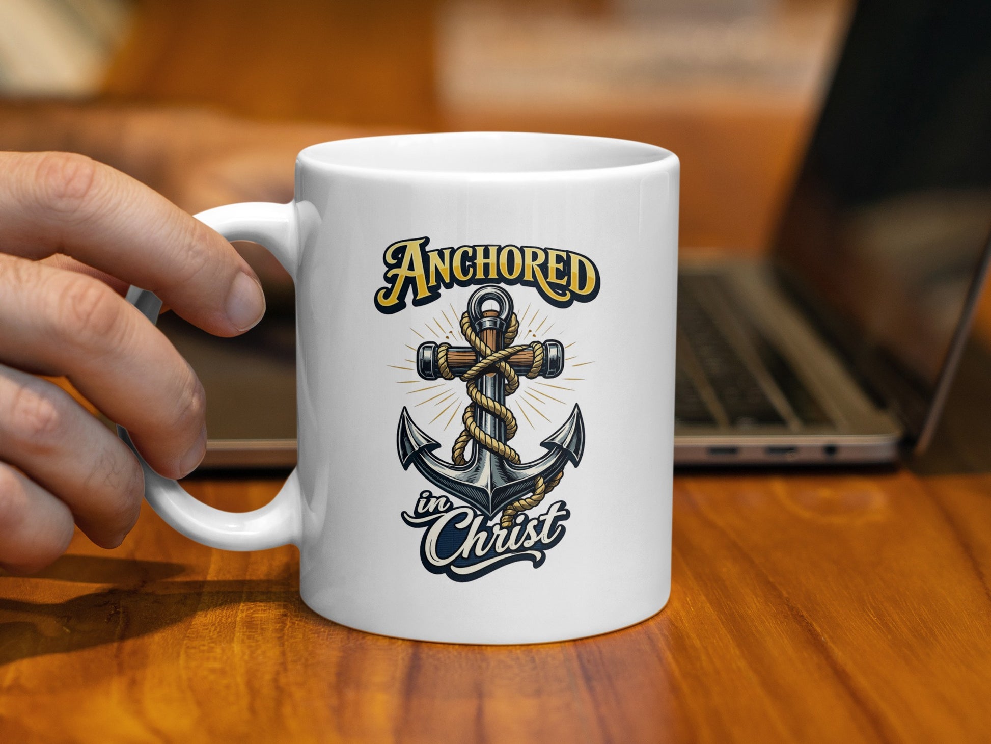 White mug with "Anchored in Christ" text and an anchor cross design.