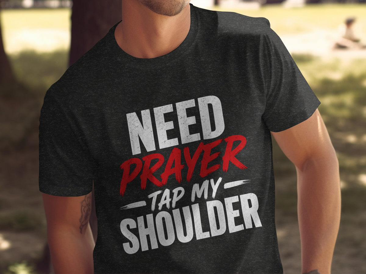 Dark t-shirt with white and red text: "NEED PRAYER - TAP MY SHOULDER"