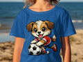 Cartoon dog in soccer uniform plays with a soccer ball on a blue t-shirt.