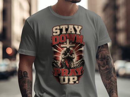 Grey t-shirt with "STAY DOWN PRAY UP" text and kneeling man.