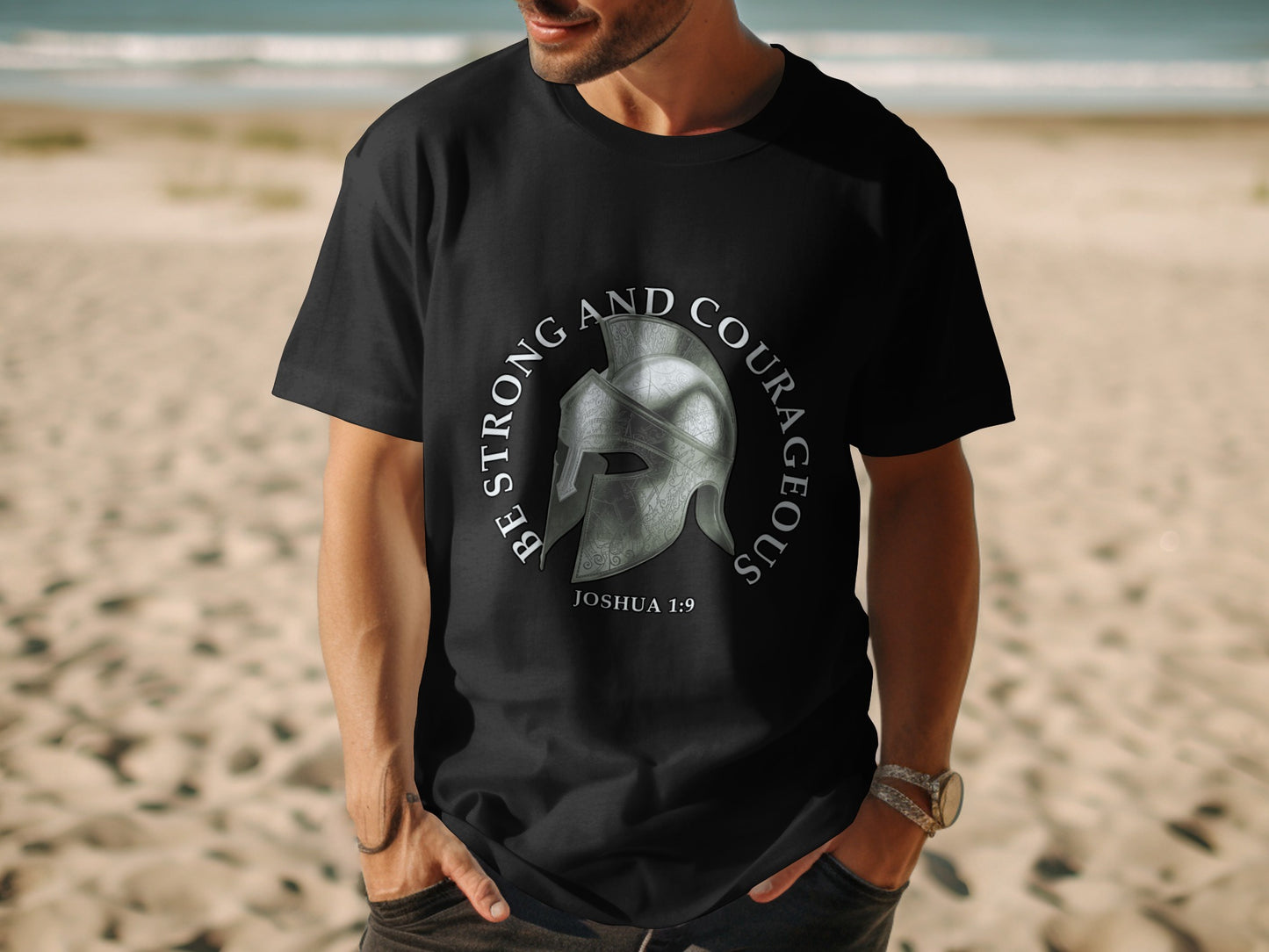 Black t-shirt with a Roman helmet graphic and text "Be Strong and Courageous Joshua 1:9".