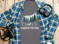Grey t-shirt with wolf and forest silhouette, text "LEADER OF THE PACK."