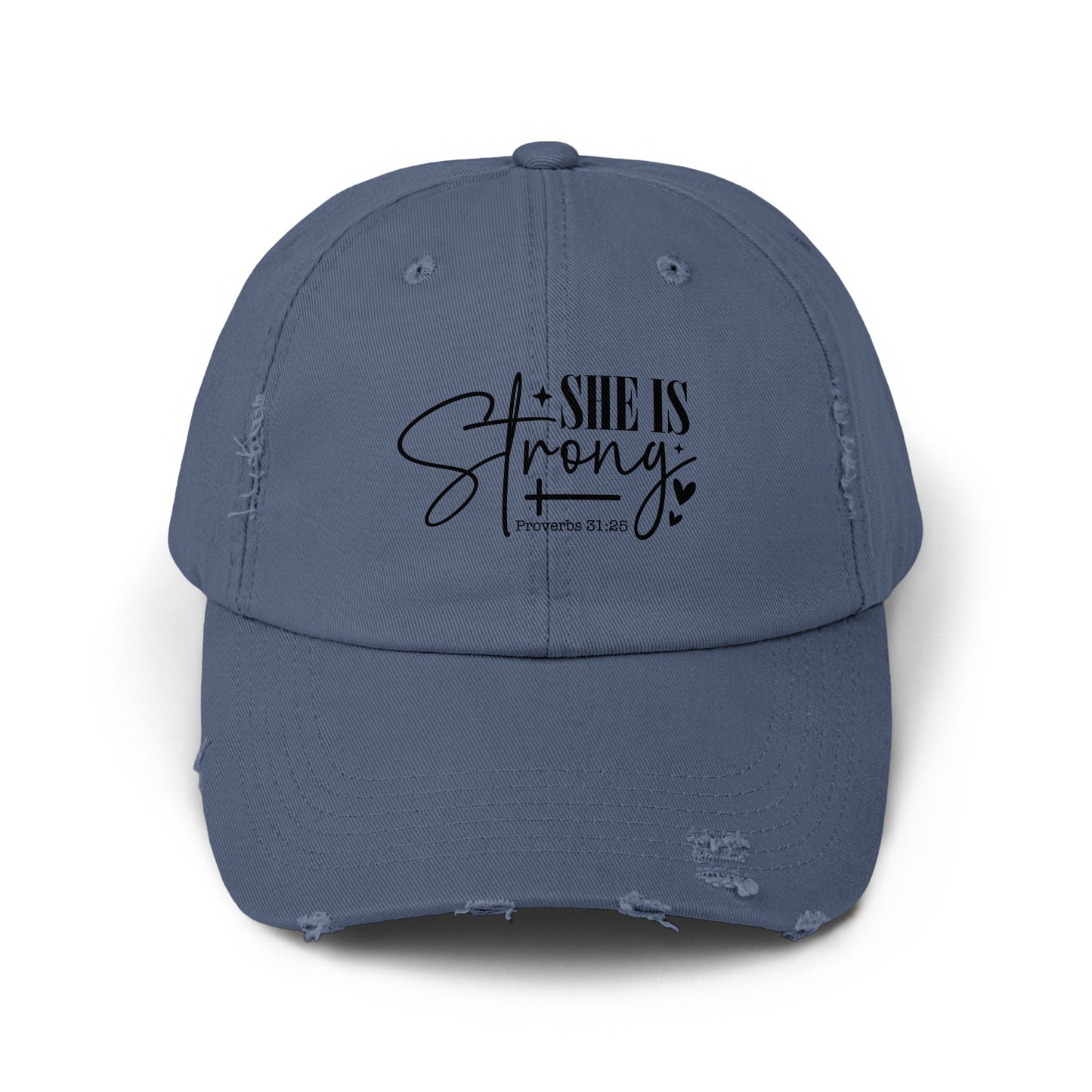 Distressed blue baseball cap with "SHE IS Strong" and "Proverbs 31:25" text.