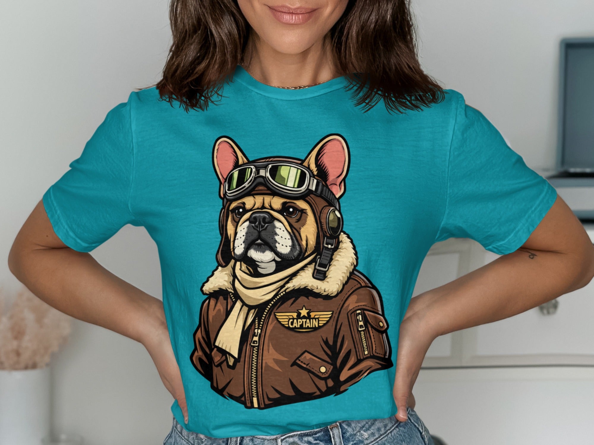 French bulldog in aviator goggles and jacket with "CAPTAIN" text.