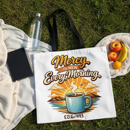 White tote bag with "Mercy Is New Every Morning" text and coffee sunrise graphic.