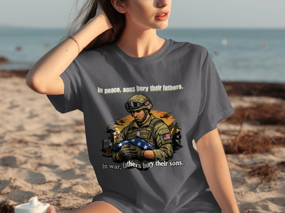 Gray t-shirt with a soldier holding a US flag graphic and text.