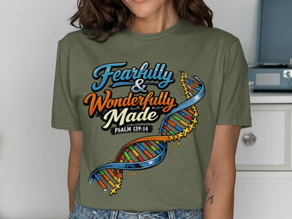 Green t-shirt with "Fearfully & Wonderfully Made" and a colorful DNA strand.