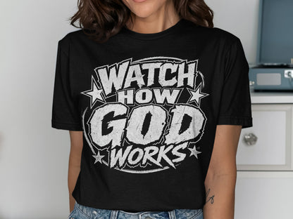 Black t-shirt with white distressed text reading "WATCH HOW GOD WORKS" and stars.