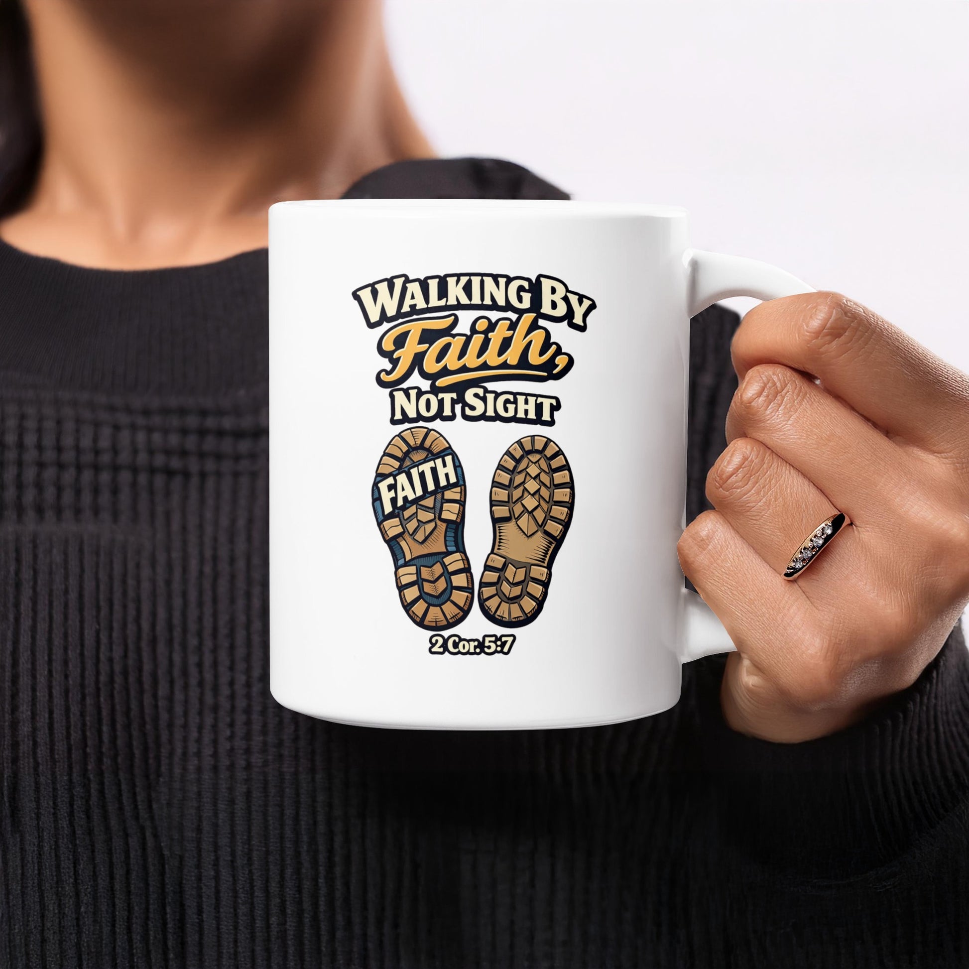 White mug with text "Walking By Faith, Not Sight" and shoe imprints.