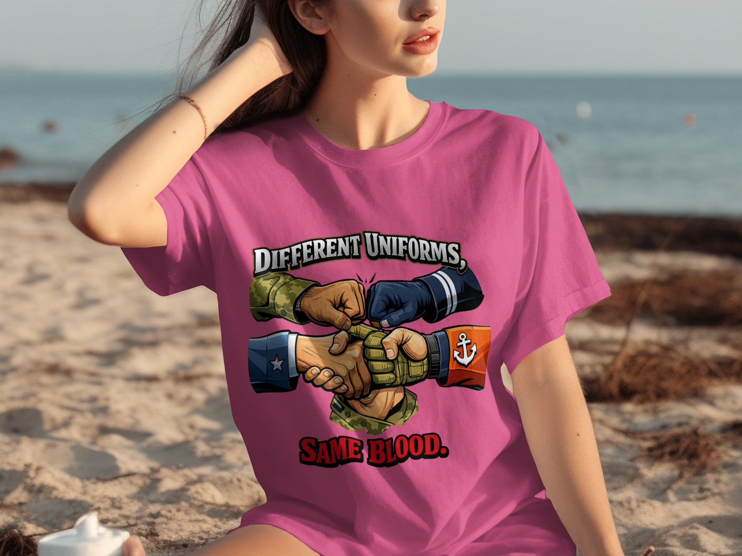 Pink t-shirt with "Different Uniforms, Same Blood." text and diverse hands in military and naval uniforms.