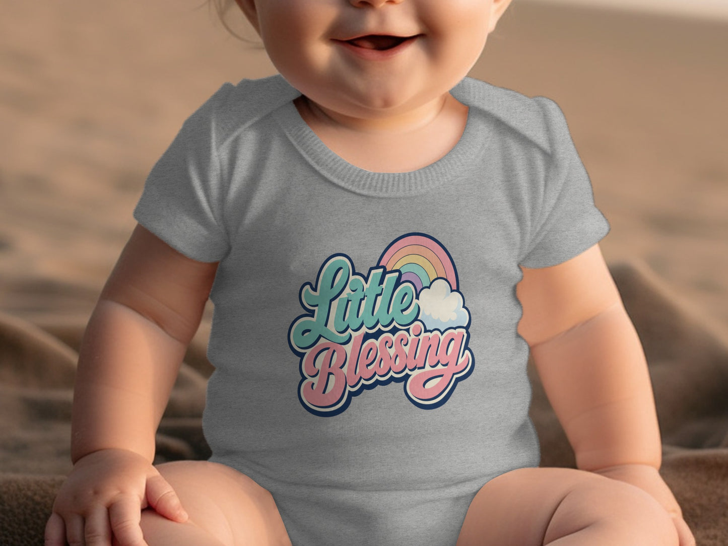 Grey baby onesie with "Little Blessing" text and rainbow graphic.