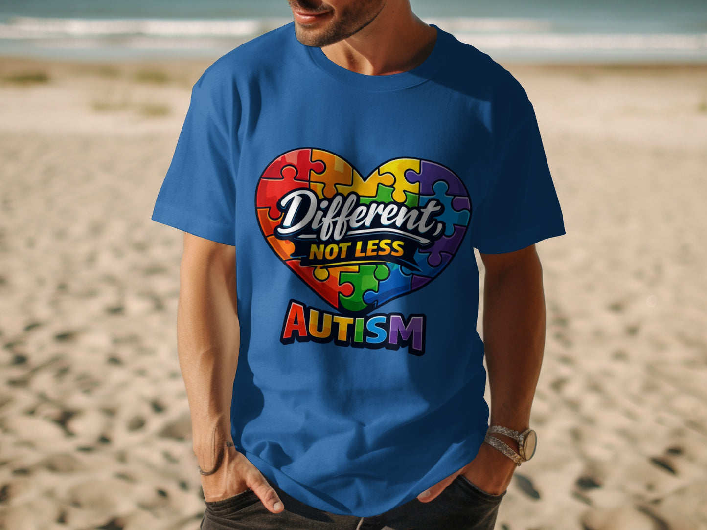Blue t-shirt with a rainbow puzzle heart graphic that reads "Different, NOT LESS AUTISM".