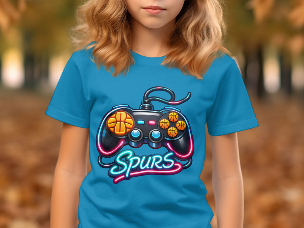 Blue t-shirt with a video game controller graphic featuring basketballs and "Spurs" text.